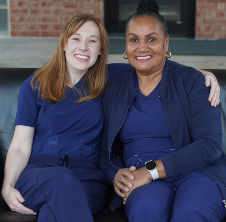 Two team members smiling